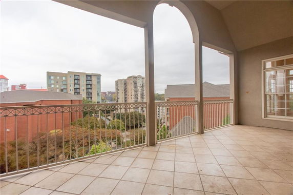 Wide-angle view of buildings from a balcony.