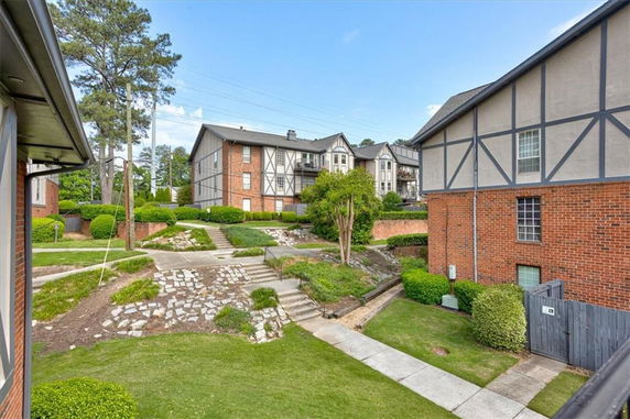 View of buildings with brick and panel exteriors in a residential area.