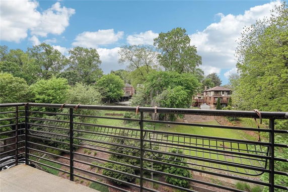 View from a building showing a landscaped garden and distant houses.