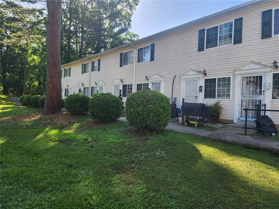 Front view of a two-story townhouse building with multiple units.