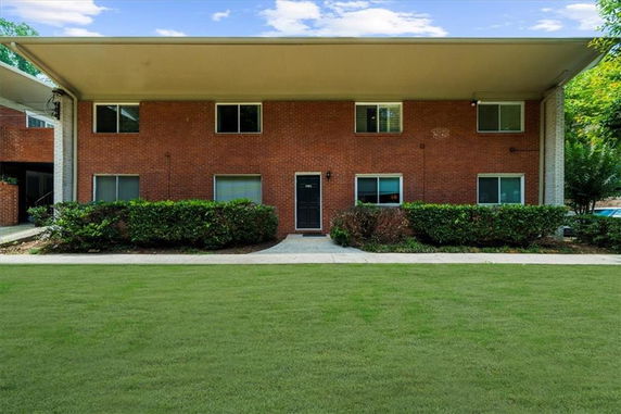 Front view of a two-story brick building with a flat roof and symmetrical windows.