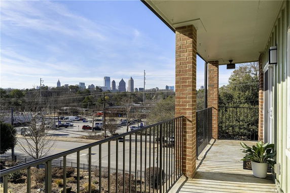 Elevated view from a balcony overlooking an urban skyline.