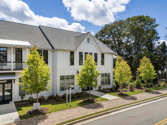 Front view of a two-story house with multiple windows and a gable roof.