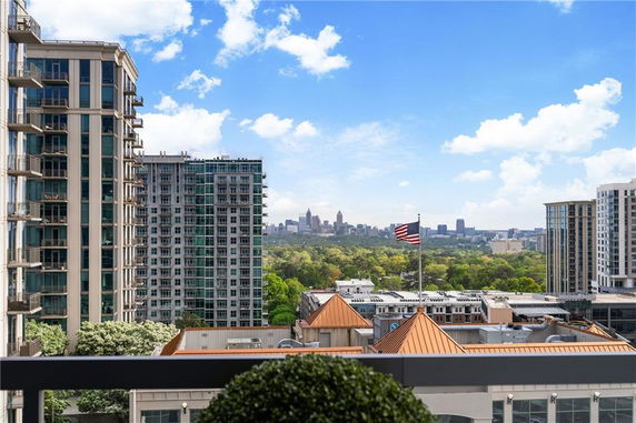 Panoramic view of a cityscape with high-rise buildings and a distant skyline.