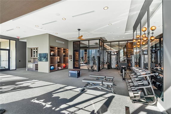 Interior view of a gym with exercise equipment and mirrored walls.