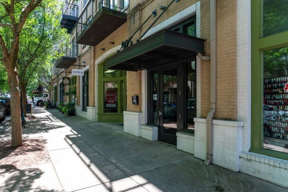 Front view of a building with balconies and storefronts.