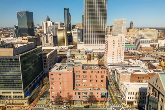 Aerial view of a cityscape with multiple high-rise buildings and streets.