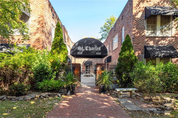 Front view of a brick apartment building with a black awning labeled 'St. Charles'.