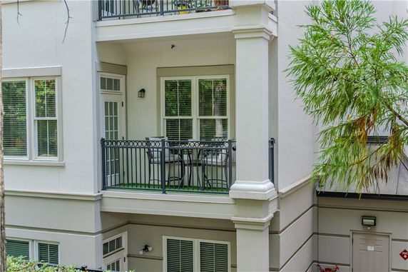 Front view of a building with a balcony featuring metal railings.