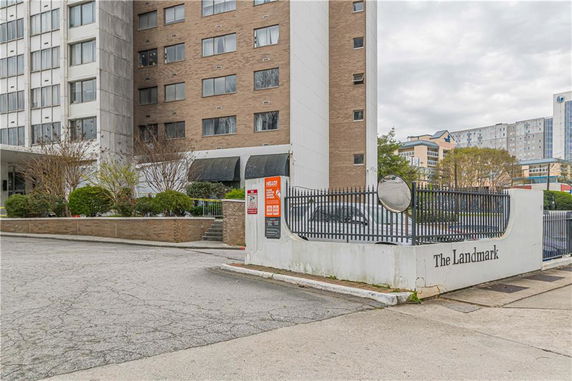 Front view of a multi-story building complex with a gated entrance labeled 'The Landmark'.