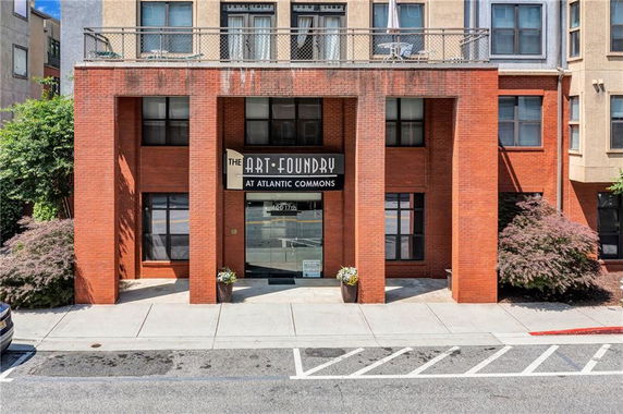 Front view of a building with a brick facade and signage for The Art Foundry at Atlantic Commons.