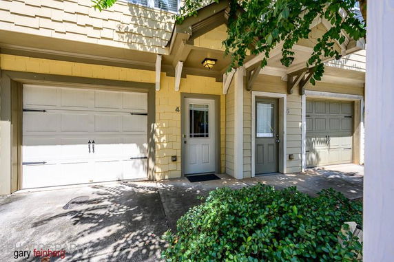 Front view of a townhouse with a garage and entrance door.