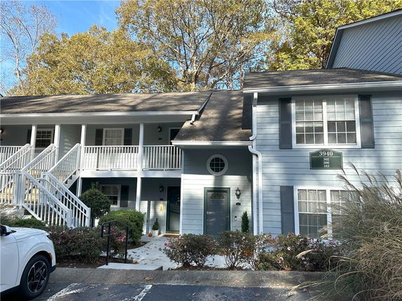 Front view of a two-story residential building with blue siding and white trim.