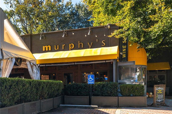 Front view of a building with a yellow canopy and signage reading 'murphy's'.