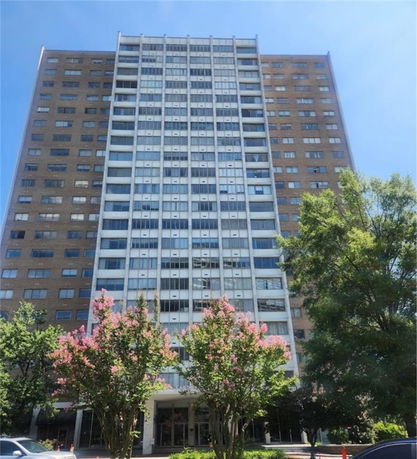 Front view of a tall multi-story residential building.