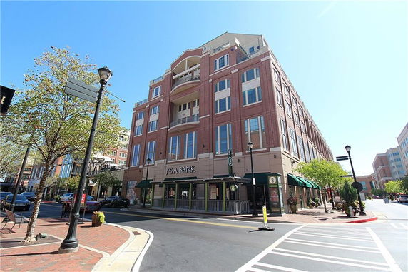 Front view of a multi-story commercial building with a bank on the ground floor.