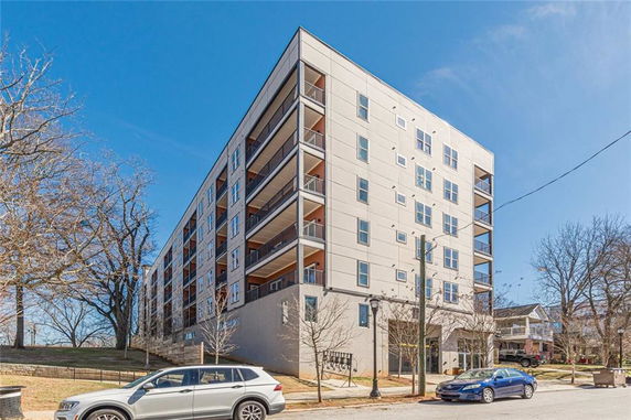 Front view of a multistory apartment building with balconies.