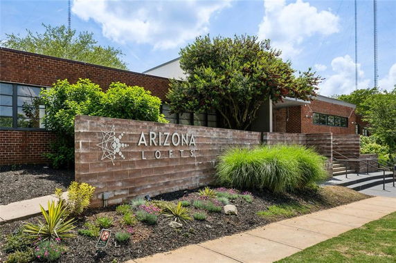 Front view of a building with brick exterior and a sign labeled 'Arizona Lofts'.