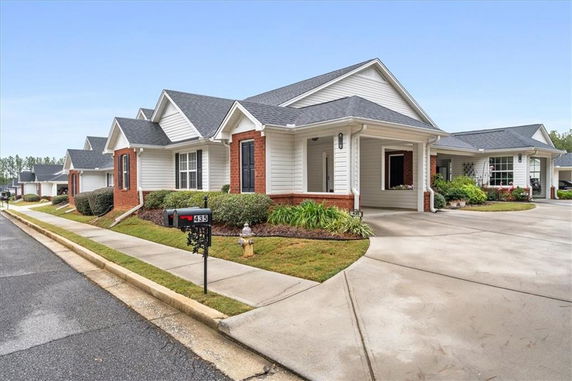 Front view of a single-story house with driveway and front porch.