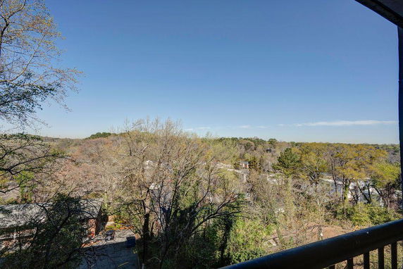 View of surrounding trees and landscape from a building.