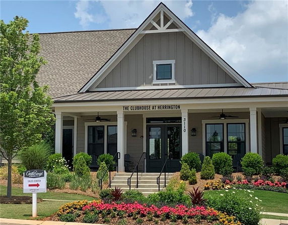 Front view of a clubhouse with a pitched roof and porch.