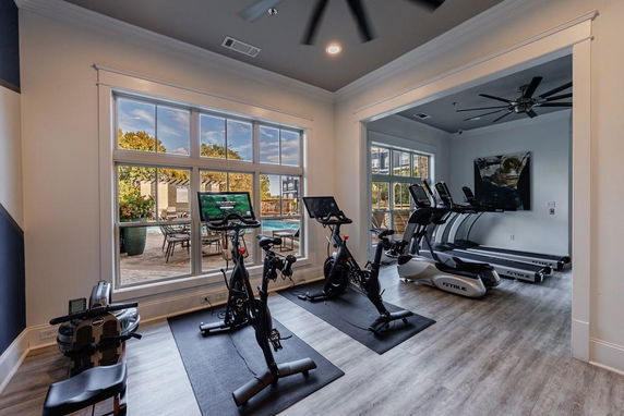 Indoor gym area with exercise bikes and treadmills.