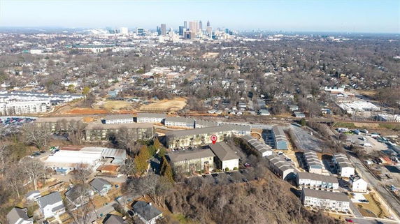 Aerial view of a residential area with a city skyline in the background.