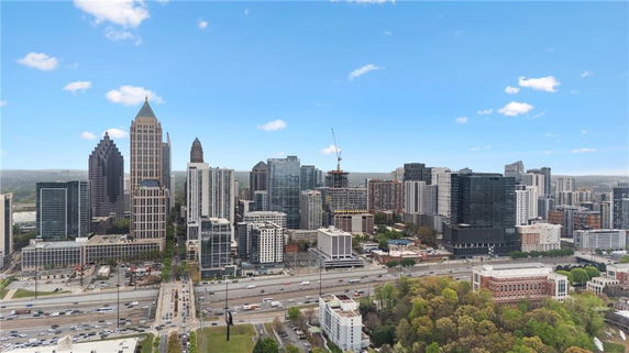 Panoramic view of a city skyline with tall buildings and roads.