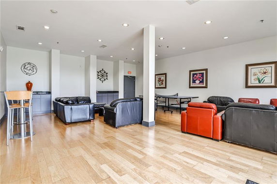 Interior view of a recreation room with seating and a ping pong table.