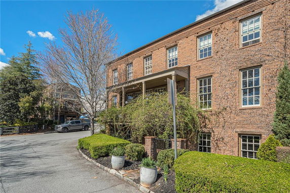Front view of a two-story brick building with multiple windows.