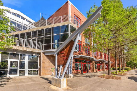 Front view of a multi-story building with modern architectural elements and large windows.