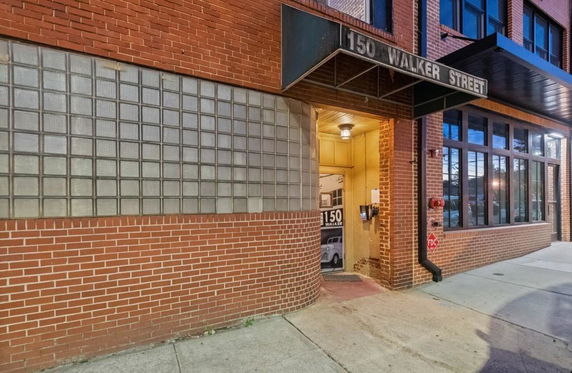 Front view of a brick building entrance labeled '150 Walker Street'.