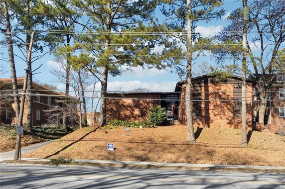 Front view of a brick building with multiple stories.