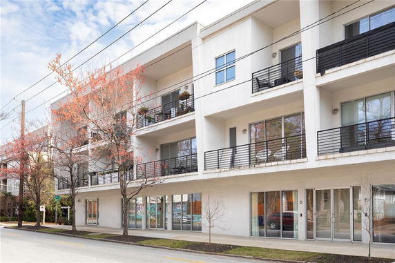 Front view of a multi-story building with balconies.