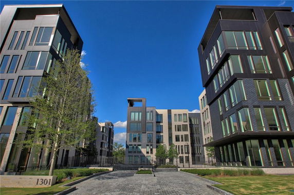 Front view of modern multi-story residential buildings with large windows.