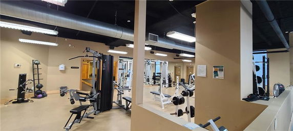 Interior view of a gym area with various exercise equipment.