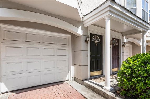Front view of a house with a garage and two entrances.