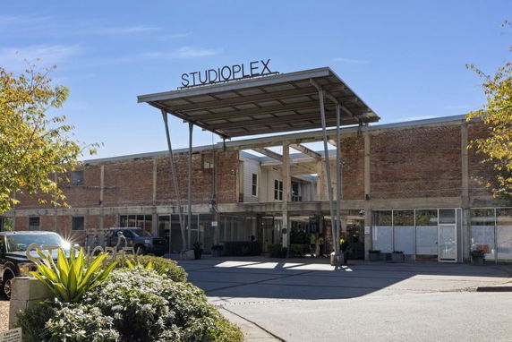 Front view of a commercial building with a large sign on top.