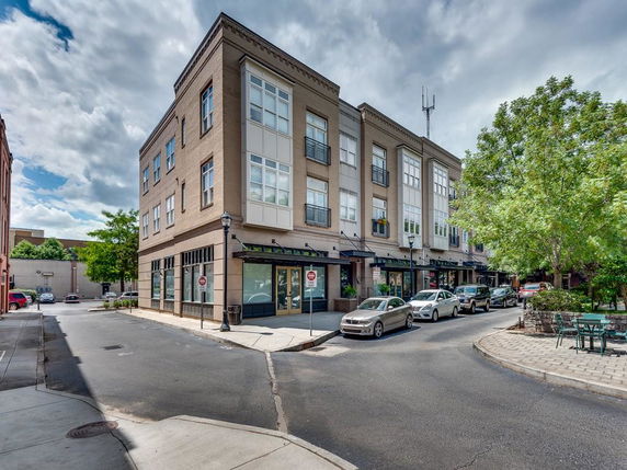 Front view of a three-story commercial building on a street corner.