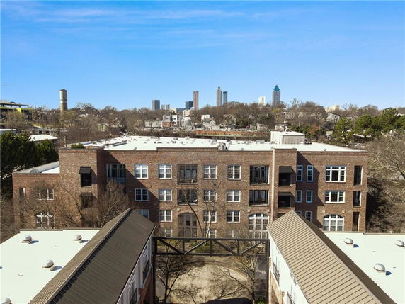 Urban landscape view with multiple buildings and city skyline in the background.