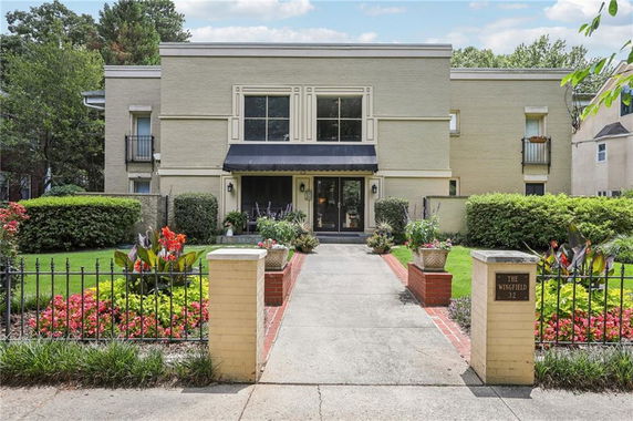 Front view of a modern two-story house with a central entrance and symmetrical design.