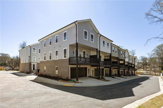 Front view of a multi-story building with multiple garages.