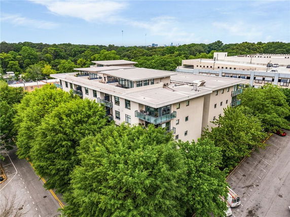 Elevated view of a multi-story building with flat roof and balconies.