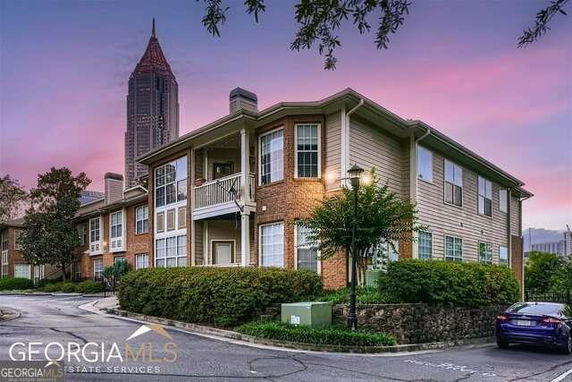 Front view of a multi-story residential building with balconies.