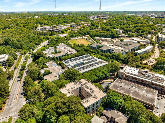 Panoramic view of an urban area with multiple buildings surrounded by trees.