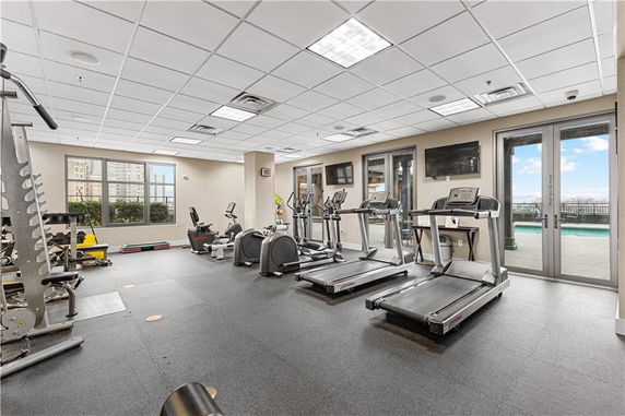 Interior view of a gym with various exercise equipment including treadmills and cycling machines.