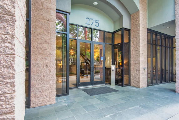 Front view of a building entrance with large glass doors and windows.