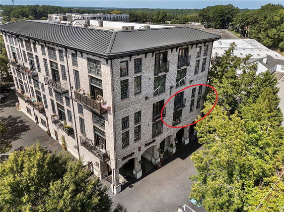 Front view of a multi-story brick building with balconies.