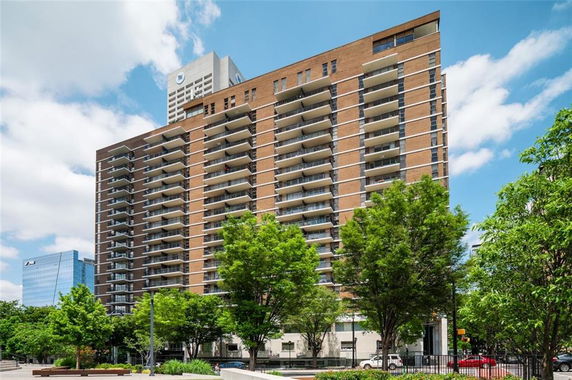 Front view of a multi-story apartment building with balconies.