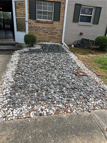 Front view of a brick house with a stone pathway.